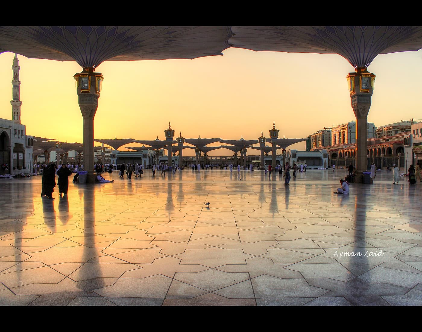 The courtyard of Masjid an-Nabawi in Madinah at sunset, under its shade umbrellas